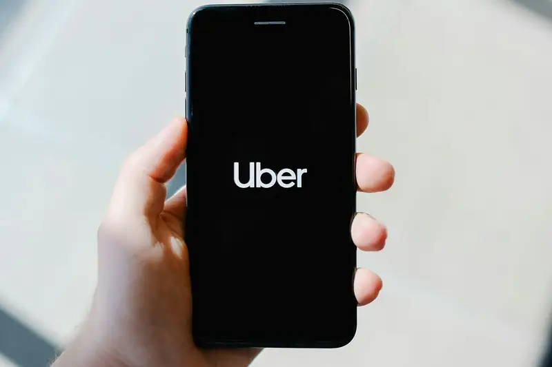 Rideshare app on a phone inside a car — Sioux Falls Uber and Lyft accident lawyer